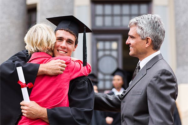 happy-male-graduate-hugging-his-mother-at-graduation-ceremony